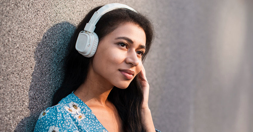 Support specialist with wireless headset monitoring multiple calls on office computer