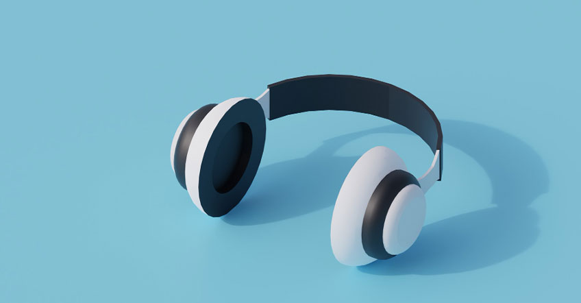 Help desk agent wearing lightweight wireless headset beside dual computer screens